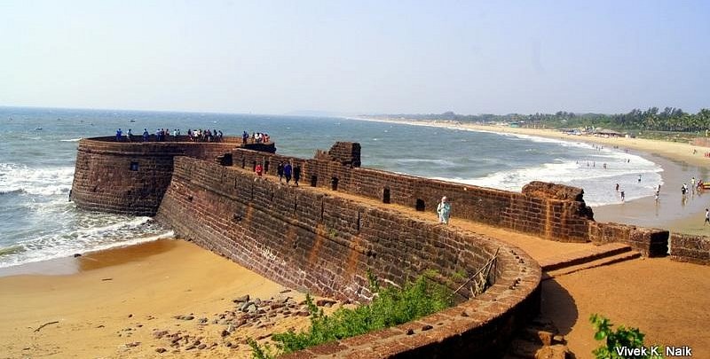 A scenic view of Panaji, the capital of Goa, featuring the Mandovi River and colorful Portuguese-style buildings.