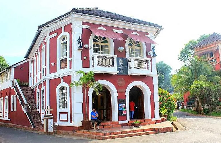 A scenic view of Panaji, the capital of Goa, featuring the Mandovi River and colorful Portuguese-style buildings.