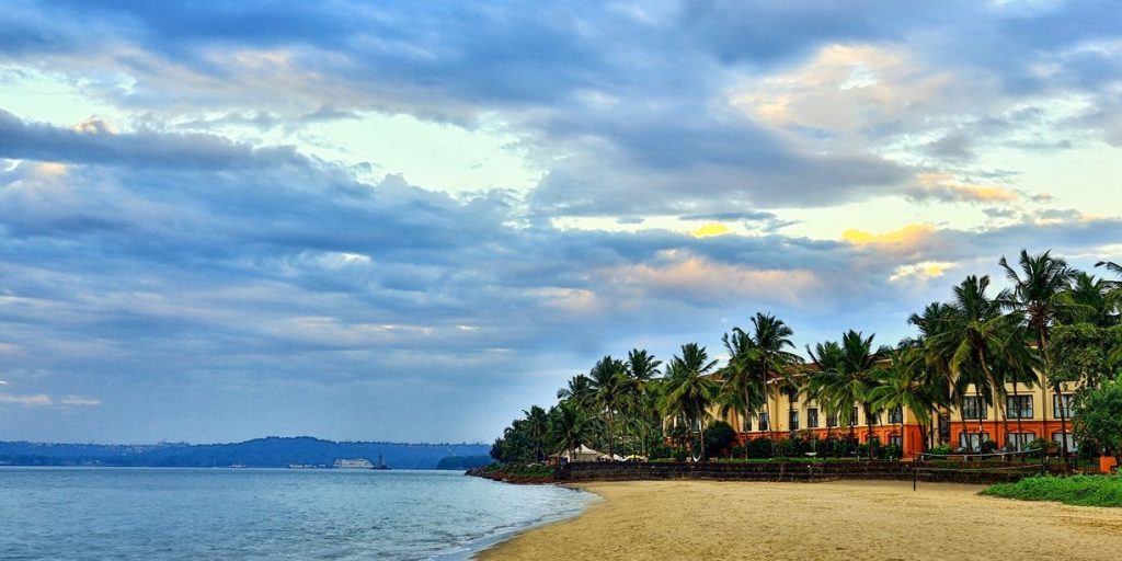 A scenic view of Panaji, the capital of Goa, featuring the Mandovi River and colorful Portuguese-style buildings.