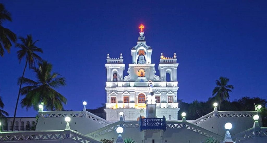 A scenic view of Panaji, the capital of Goa, featuring the Mandovi River and colorful Portuguese-style buildings.