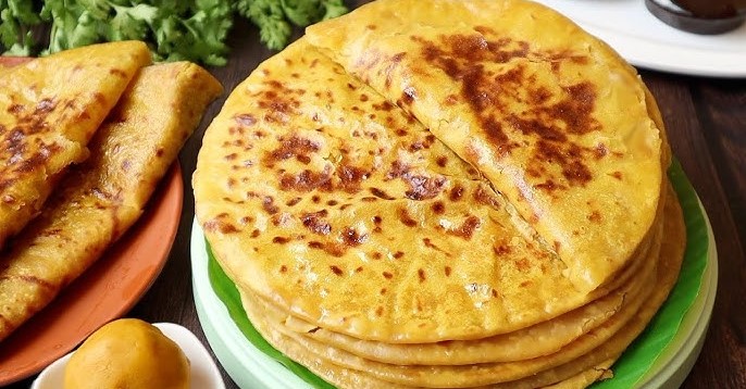 "Golden brown Bobbatlu stuffed with jaggery and chana dal, a festive Andhra sweet."